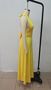 Side view showing the silhouette of a yellow halter V-neck maxi dress on mannequin
