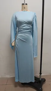 Detailed side view of a light blue long-sleeved evening gown with elegant ruched waist detail