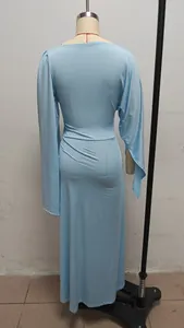 Detailed rear view of a light blue long-sleeved slim-fit evening dress on a dress form