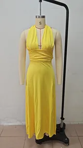 Detailed view of a yellow halter V-neck maxi dress with side slit on a mannequin