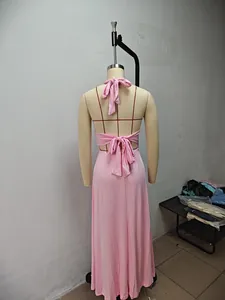 Back view of elegant pink halter maxi dress on mannequin showing tie-up back detail