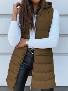 Detailed view of a woman wearing a brown hooded puffer vest over a white top