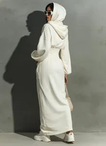 Back view of a white hooded long-sleeve dress with cinched waist detailing