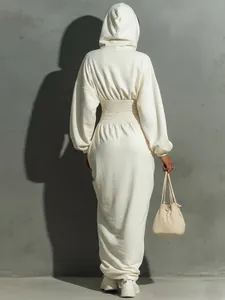 Back view of a cream hooded long sleeve dress with a smocked cinched waist detail