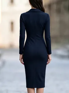 Back view detail of an elegant navy long-sleeve dress with a blazer lapel collar for work.