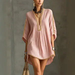 Elegant bohemian pink resort dress with deep V-neck and golden braided trim detailing