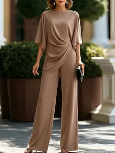 Elegant mocha two-piece set featuring a draped waist top and flowy wide-leg trousers detail.