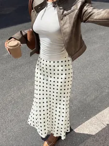 Elegant high-waisted white midi fishtail skirt with black polka dots for chic fall style