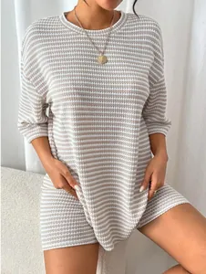 Close-up view of a beige and white striped ribbed knit two-piece loungewear set
