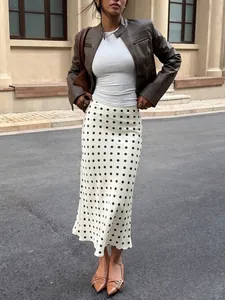 Elegant high waist white midi skirt with black polka dots and fishtail hemline.