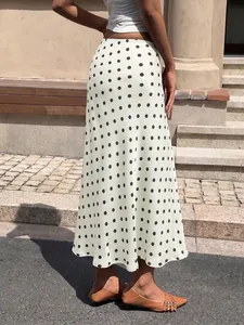 Rear view of an elegant high-waisted white midi skirt with classic black polka dots.