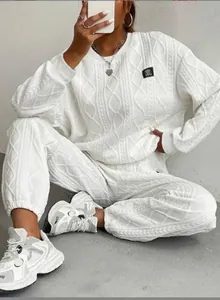 Detalle de la sudadera con textura jacquard blanca y el conjunto de pantalón casual