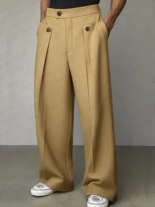 Dettaglio dei pantaloni a gamba larga color cammello con design a pieghe e bottoni
