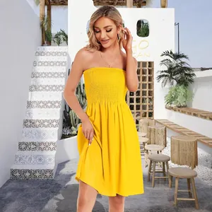 Elegant yellow summer strapless tube dress for women in resort outdoor setting