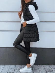 Stylish woman wearing a long black hooded puffer vest with side buttons detail