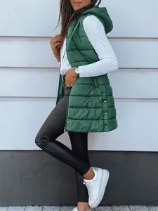 Detailed view of women's long hooded green quilted gilet with side button accents