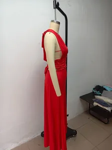 Detail view of a vibrant red halter neck maxi dress with a deep V-neckline and side slit.
