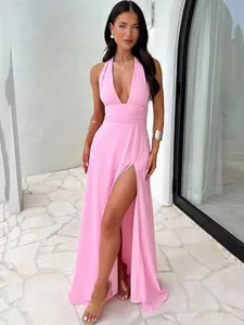 Elegant pink halter neck maxi dress with deep V-neck and high thigh slit detail.
