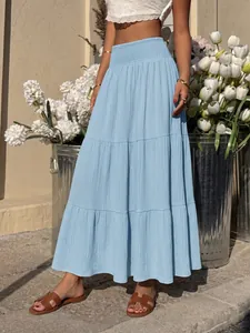 Detail view of a light blue tiered maxi skirt with a shirred high waist for summer