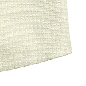 Detailed close-up showing the cream textured fabric of a fake two-piece blazer dress