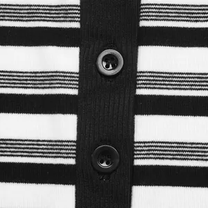 Detailed close-up view of a black and white striped knit dress showing buttons and texture