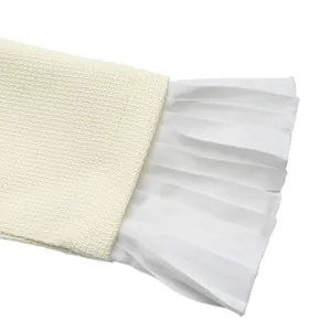 Close-up of pleated flare cuff detail on a cream textured fake two-piece suit dress