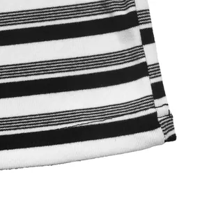 Detail view of black and white striped T-shirt dress fabric texture and hem line