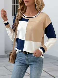 Casual color-block knit sweater with round neck, featuring white, tan, and navy patterns.