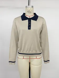 Detailed view of women's beige long sleeve knit polo sweater with navy contrast collar
