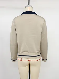 Back view of a beige women's knit sweater with navy contrast trim on mannequin.