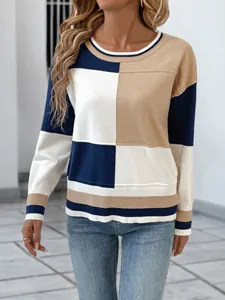 Detailed view of women's long-sleeve knit sweater with stylish color-block design.