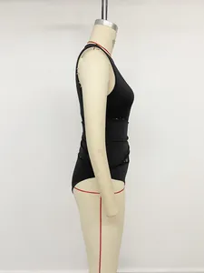 Side view of a sexy black sleeveless bodysuit with lace patchwork and twist detail