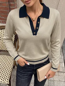 Detailed view of a beige long-sleeved knit polo sweater with navy blue contrast collar.