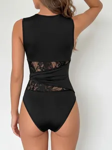 Back view detail of a black sleeveless bodysuit with floral lace cutouts and twist design