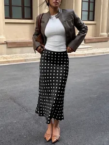 Fashionable street look featuring high-waisted polka dot midi skirt and leather jacket