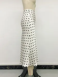Elegant high-waisted white polka dot fishtail midi skirt side view on mannequin