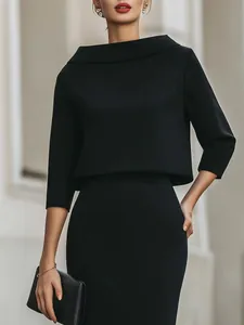 Elegant black two-piece set featuring a wide-neck top and matching pencil skirt.