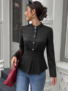 Detail of a striped long-sleeve blouse with a black cinched waist and silver buttons.