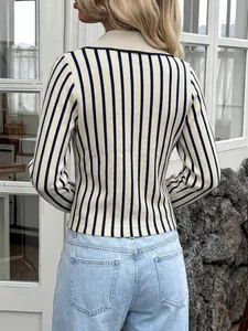 Back view of a slim-fit long sleeve knit top with cream and black vertical stripes.