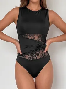 Sleek black sleeveless bodysuit featuring intricate lace panels and an elegant waist knot.