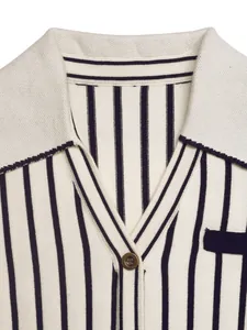 Close-up detail of an elegant cream and navy blue striped knit cardigan with spread collar