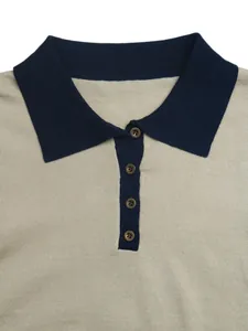 Close-up of color-block knit polo shirt with navy collar and bronze buttons