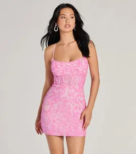 A detail shot of a stunning shimmering pink sequin mini dress worn by a model in a studio.
