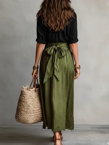 Back view detail of women's casual black shirt and olive green maxi skirt with bow waist