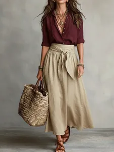 Bohemian women's two-piece set with burgundy shirt and beige belted maxi skirt.