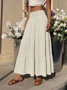 Detail of high waist elastic shirred tiered maxi skirt in cream white color