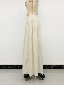 Full view of a cream-colored tiered smocked maxi skirt shown on a professional dress form