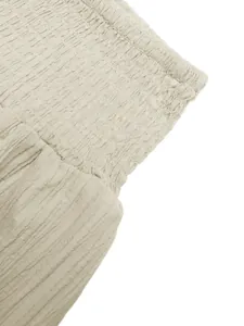 Detailed macro shot of the high waist smocked elastic waistband on a summer skirt