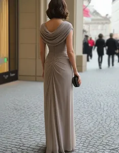 A detailed back view of an elegant mauve evening gown with a cowl neck and pleated design