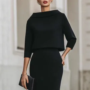 Elegant black two-piece outfit featuring boat neck top and bodycon skirt for business